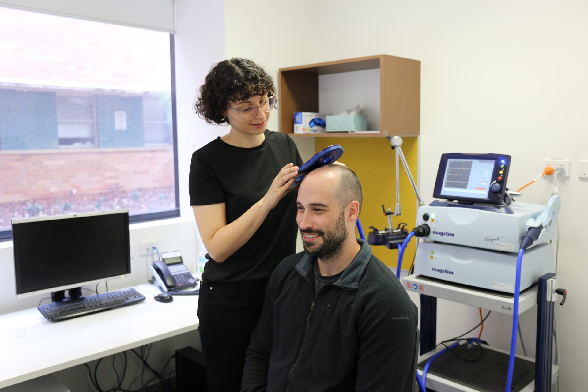 L-R Dr Aleksandra Miljevic and Dr Jamie Beros with the TMS machine in the Perron Institute Clinic